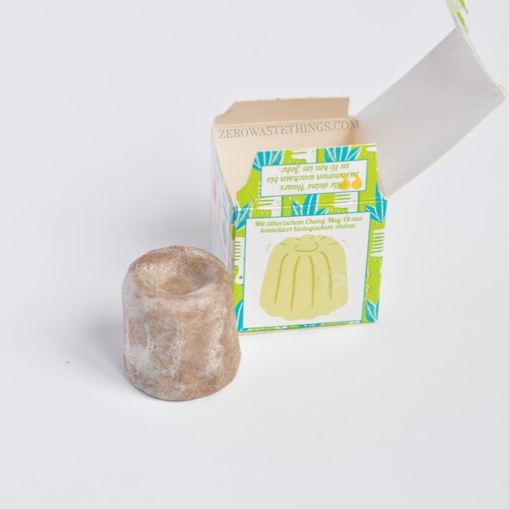Slightly used Lamazuna-zero-waste-solid-bar-shampoo with a green recyclable box.